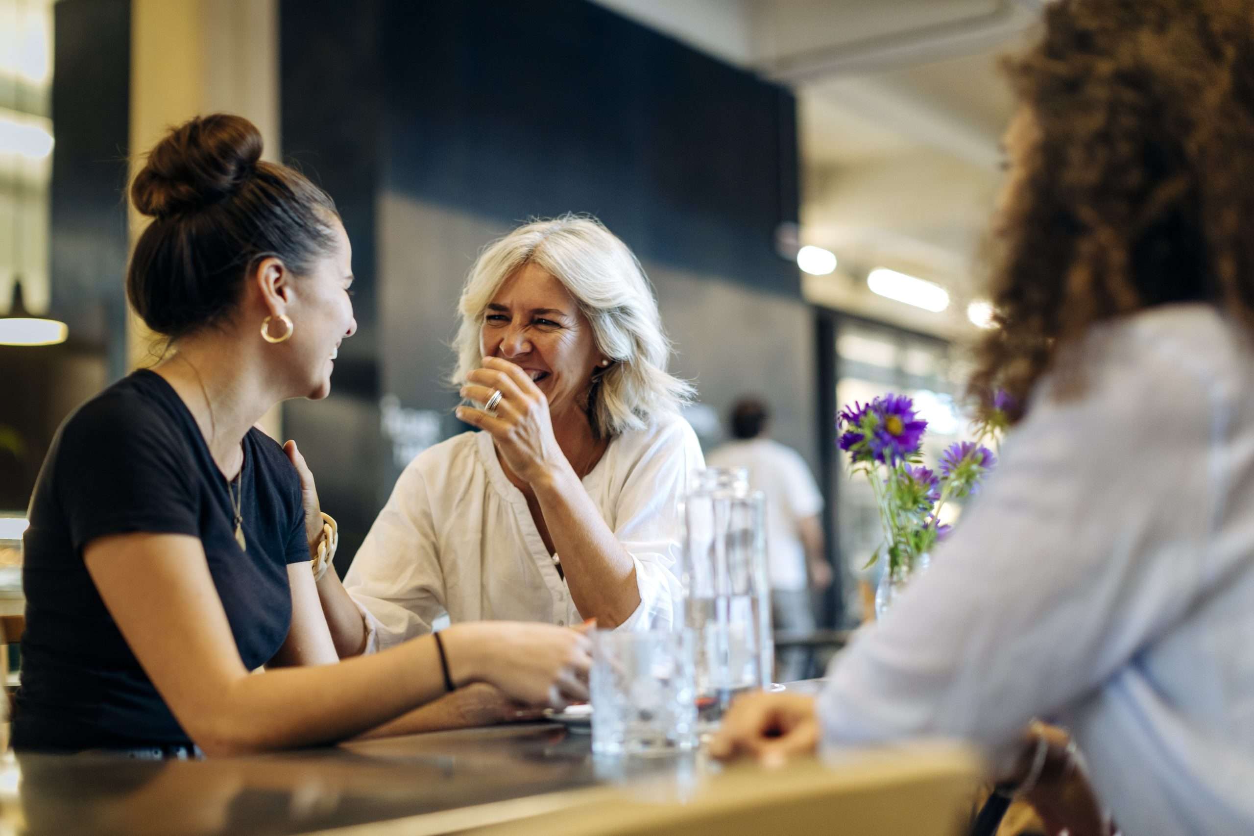 Women meeting in bistro, having fun and laughing.